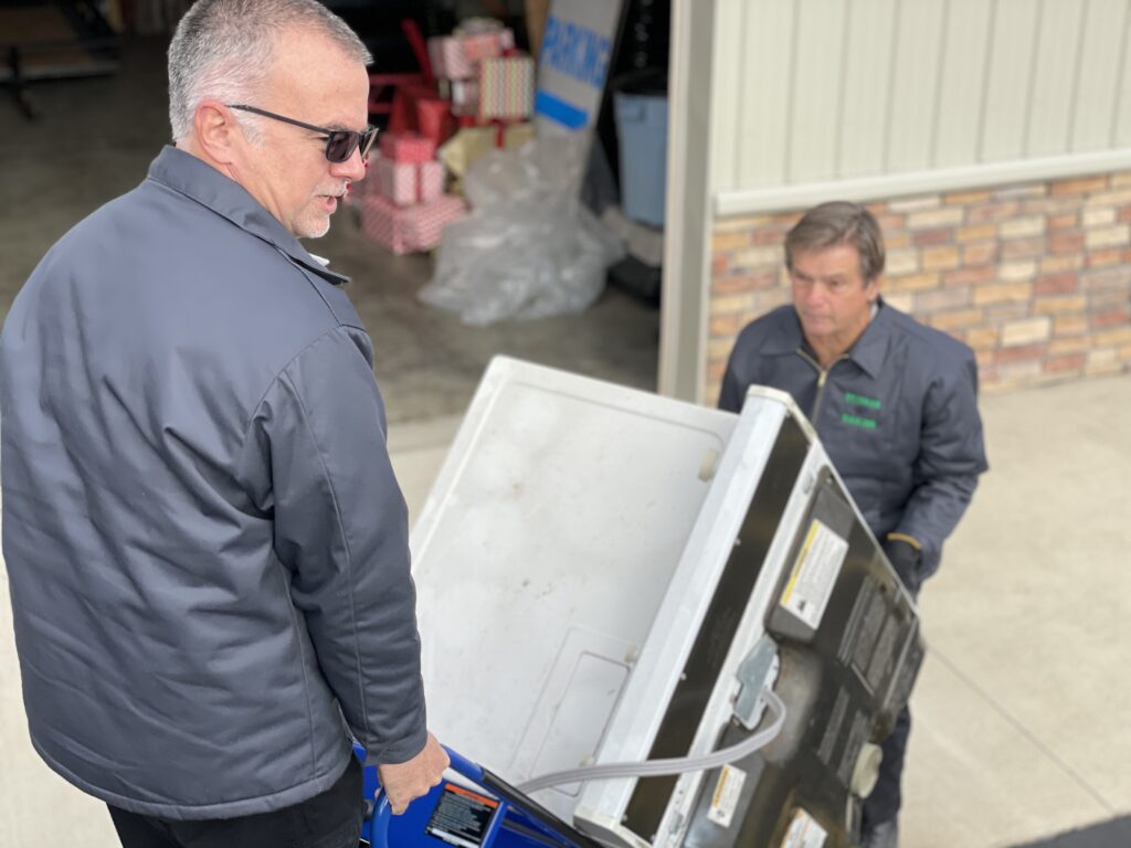 Two men doing Junk Removal work in Columbus, IN.