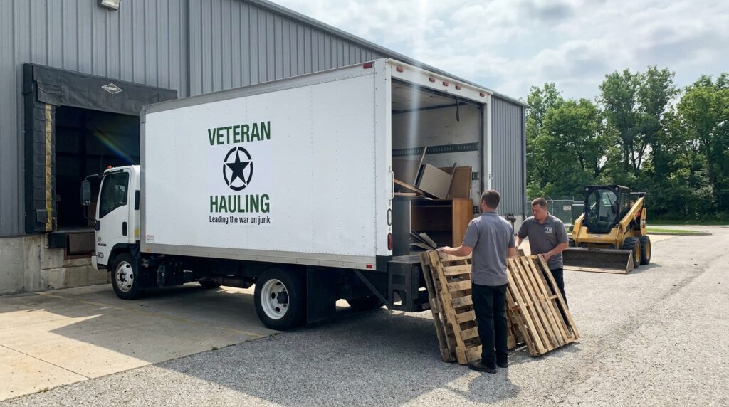 Veteran Hauling white Isuzu box truck backed up to a Central Indiana warehouse loading=